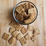 crackers on a board and in a glass bowl