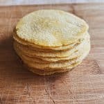 tortillas stacked on a wooden surface