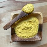 homemade mustard in a wooden bowl with spoon