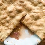 freshly baked rhubarb pie with a slice missing