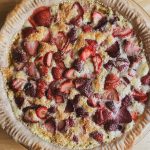 strawberry custard pie freshly baked on a wooden table