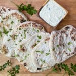 sourdough flatbread laid out on a wood surface with ranch dip above