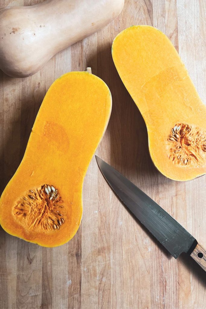 butternut squash sliced in half with a knife
