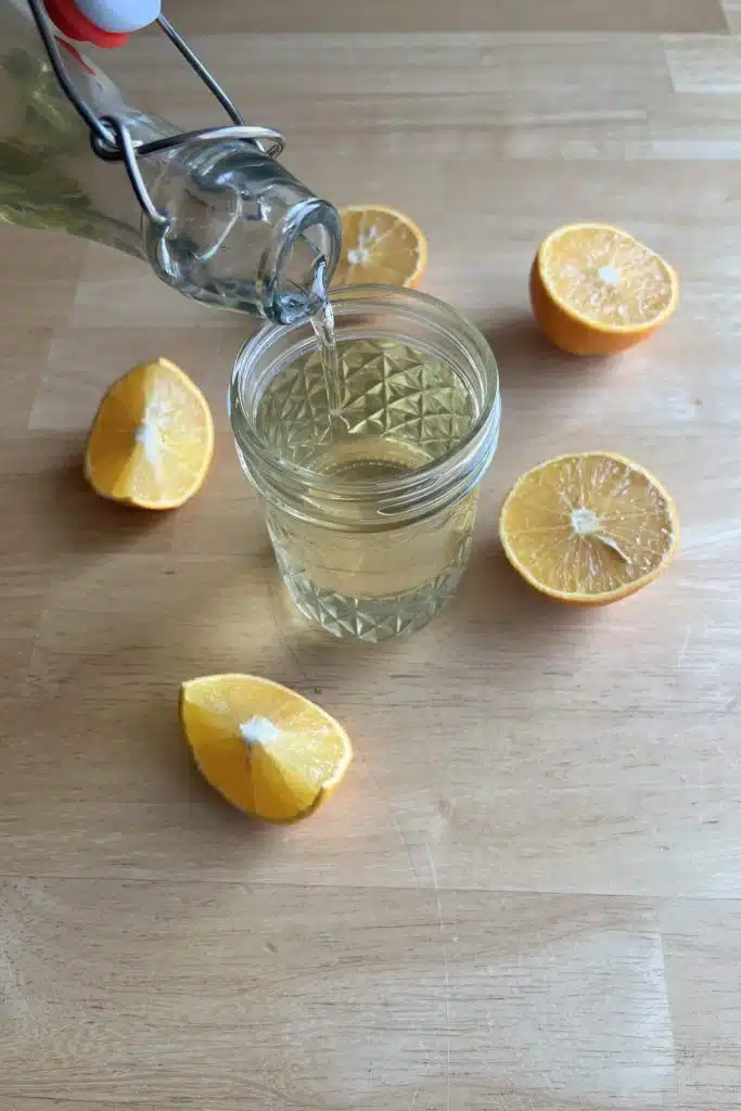 simple syrup being poured into a glass